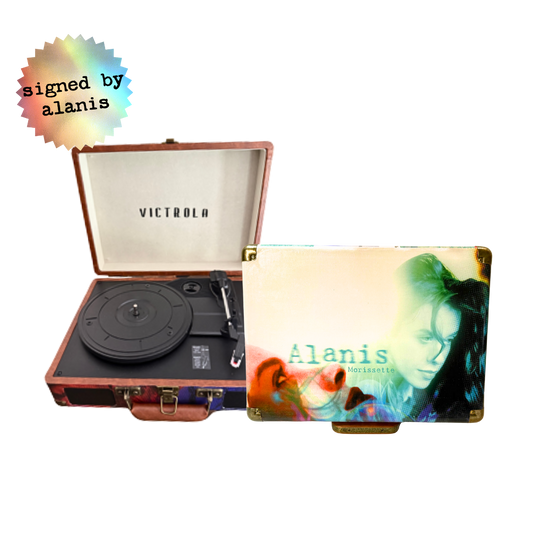 Victrola record player in rose gold with black vinyl and white interior, signed by alanis morissette.