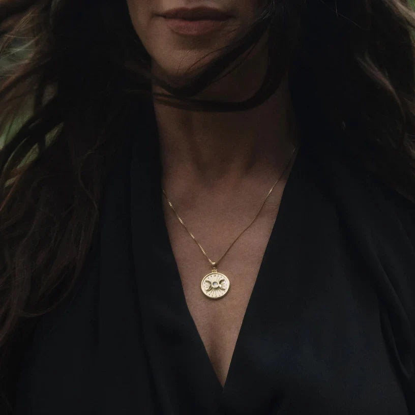 Gold coin pendant necklace.
