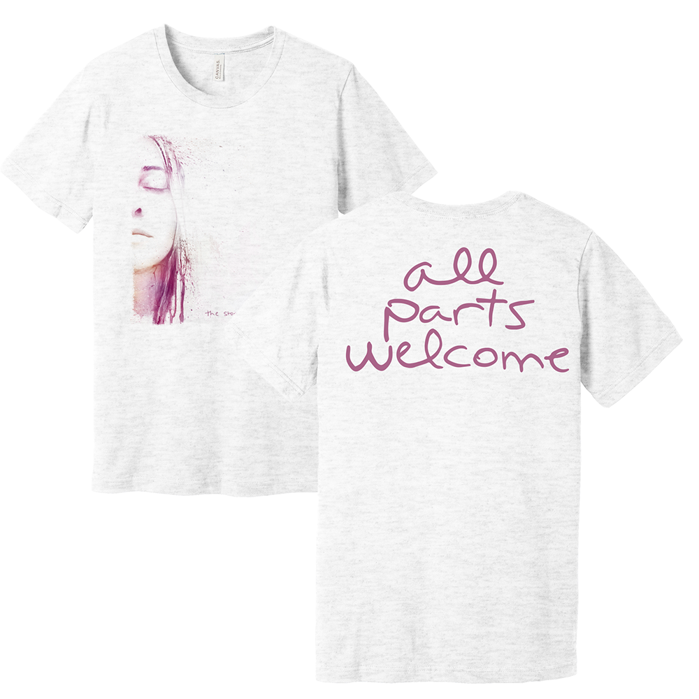 White short-sleeved t-shirt with a woman’s face illustration on the front and ’all parts welcome’ text on the back.