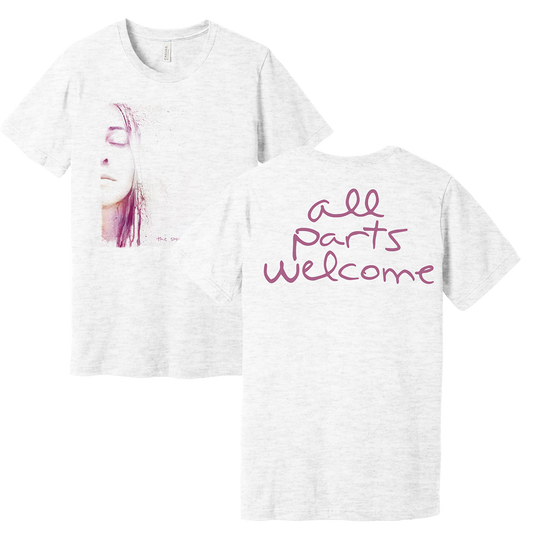 White short-sleeved t-shirt with a woman’s face illustration on the front and ’all parts welcome’ text on the back.